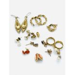 Eleven pairs of various yellow metal earrings, some with stones