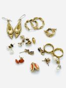 Eleven pairs of various yellow metal earrings, some with stones