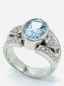 Platinum oval aquamarine set ring with diamonds to shoulders.
