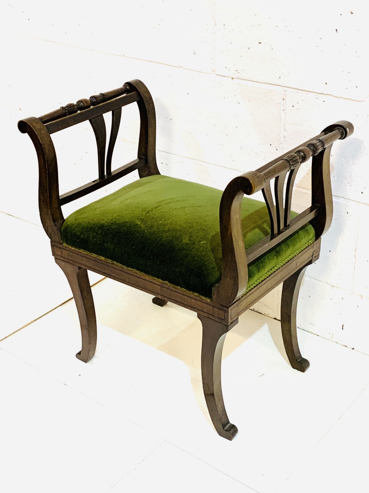 Mahogany Empire style stool with green velvet cushion.