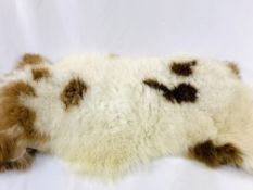 Brown and white animal skin style rug.