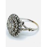 White gold diamond cluster ring.