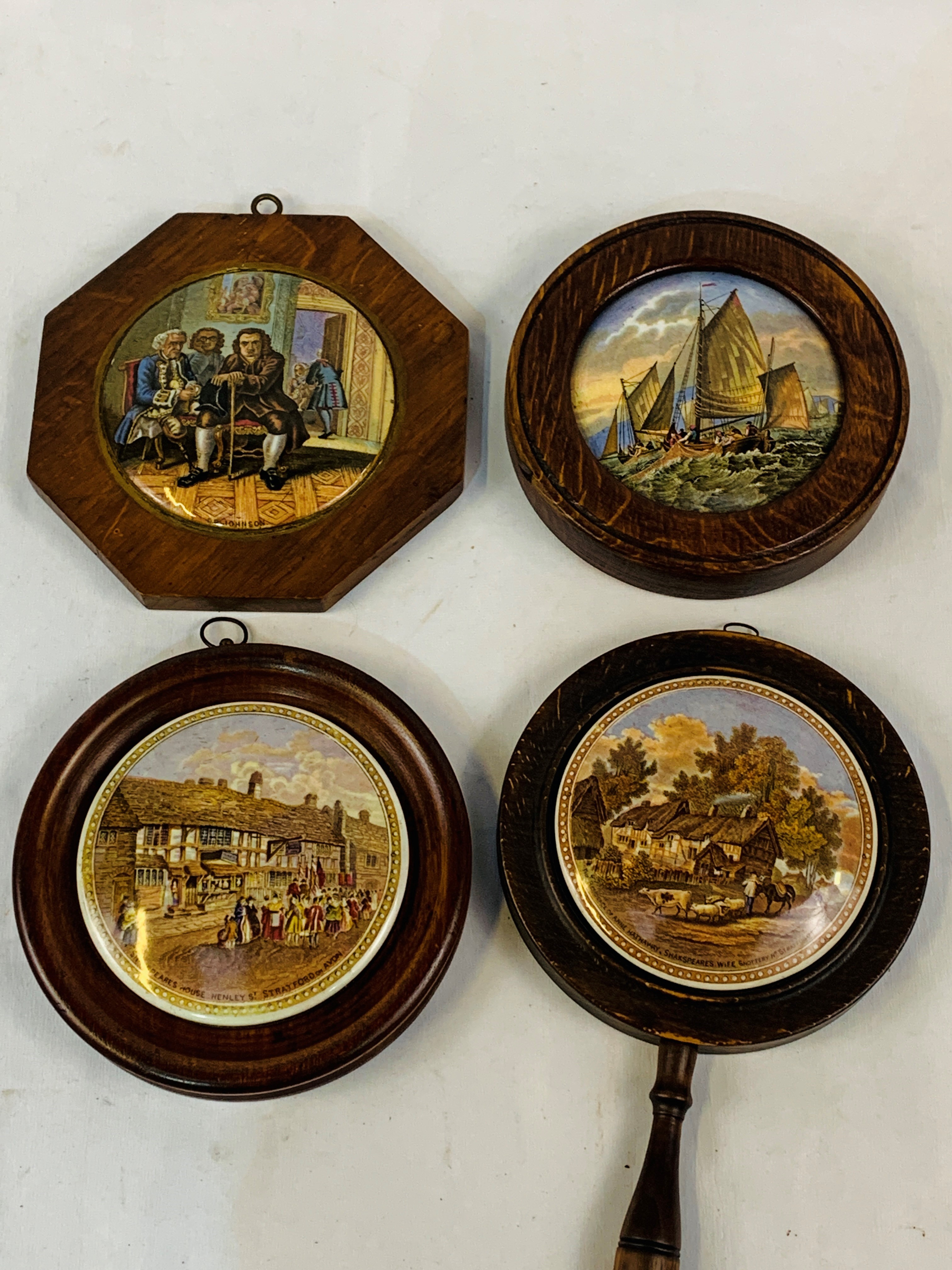 Four assorted Victorian pot lids in hardwood frames.