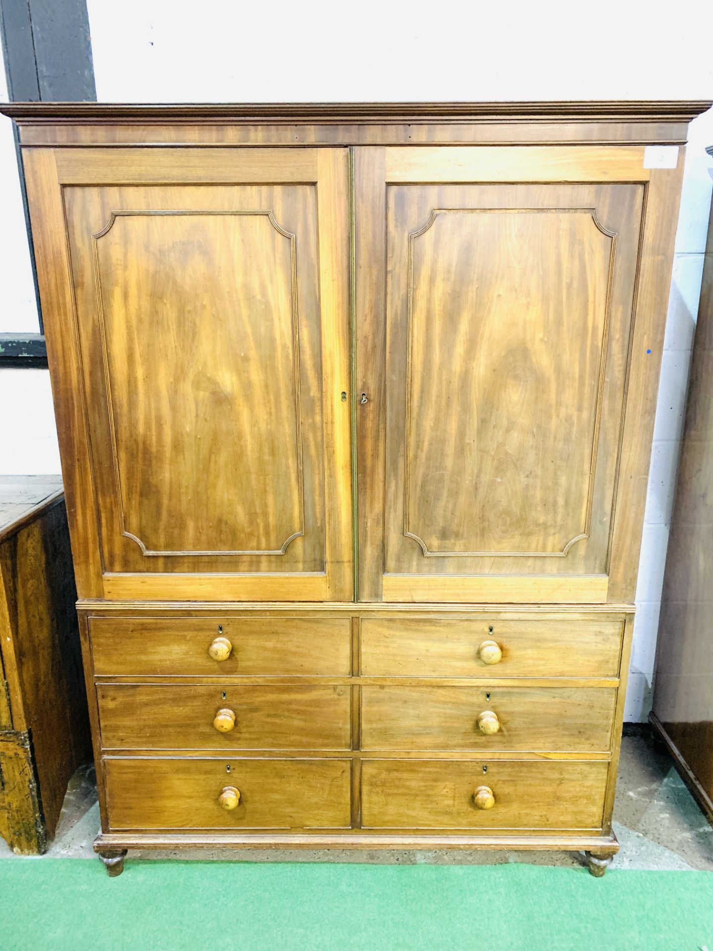 Victorian mahogany linen press over chest of 3 graduated drawers.