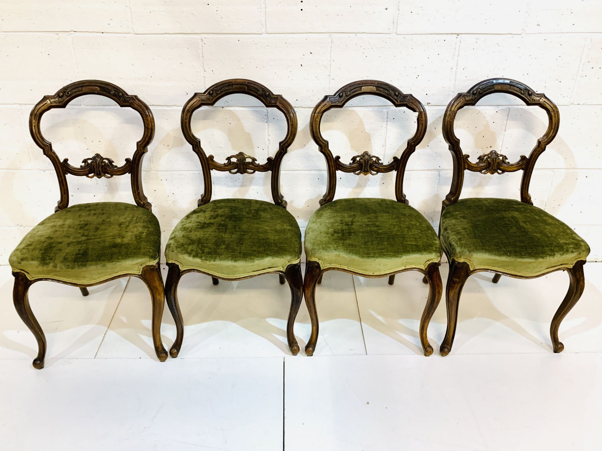 Set of four Victorian mahogany balloon back dining chairs.