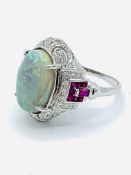 18ct white gold opal set ring with rubies and diamonds to shoulders.