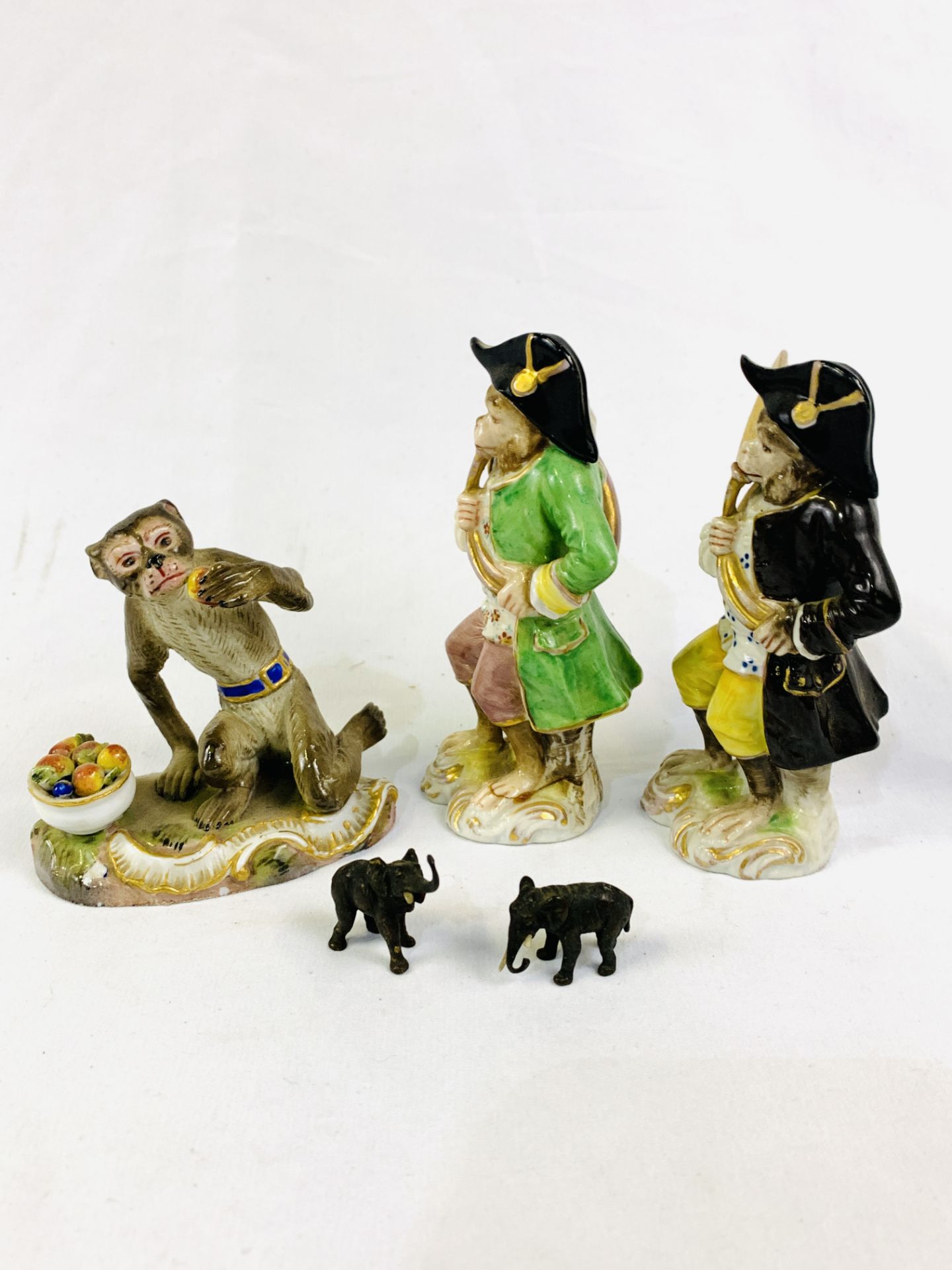 Two Capodimonte "Monkey Band" figurines; a Meissen monkey figurine; two elephant figurines; and othe