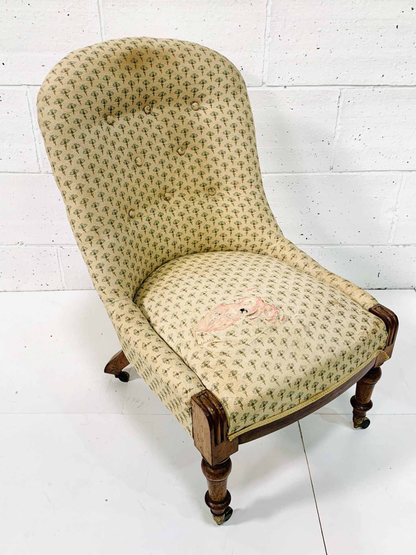 Victorian lady's drawing room chair with button back upholstery.