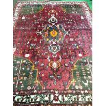 Hand knotted red ground Middle Eastern carpet