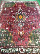 Hand knotted red ground Middle Eastern carpet