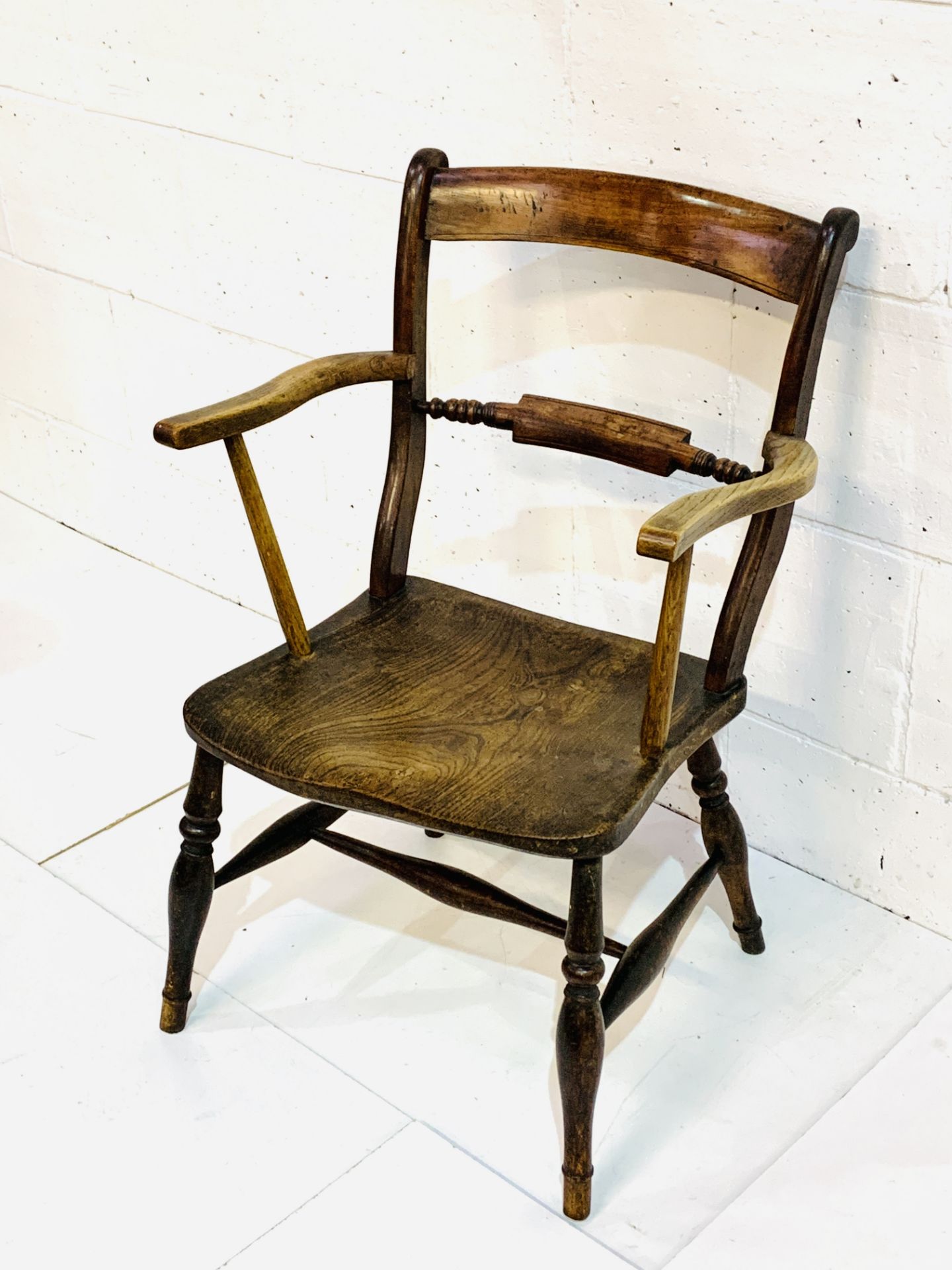 Victorian elm seat ladder back elbow chair.
