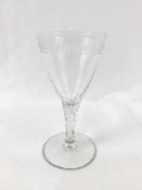 An 18th Century cut and engraved wine glass.