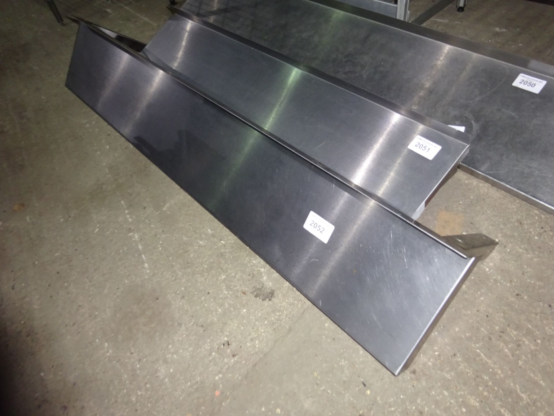 Stainless steel wall shelf with brackets, width 150cms, depth 25cms.