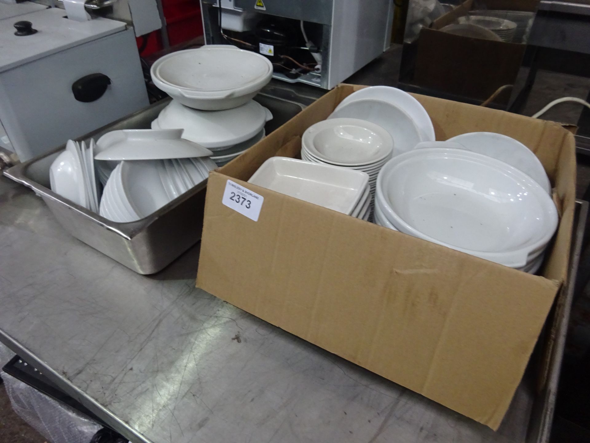 Two boxes of white china.