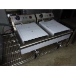 Infernus twin tank fryer with drain to front.