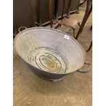 Oval tin bath with two handles. This item carries VAT.