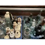 A large quantity of antique glass bottles and stoneware jars