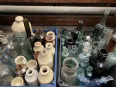 A large quantity of antique glass bottles and stoneware jars