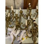 Four gilt metal three branch wall lights