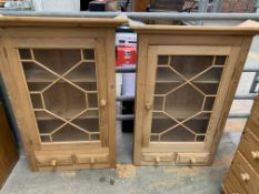 Two pine wall hanging cabinets, with glazed doors over two drawers