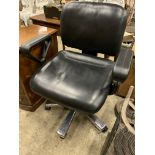 Black leather effect swivel armchair