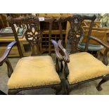 Pair of carved mahogany open arm chairs