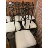 Six metal framed dining chairs with cream upholstered seats.