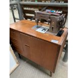 Mahogany Singer 306K electric sewing machine in a cabinet.