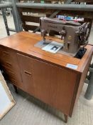 Mahogany Singer 306K electric sewing machine in a cabinet.