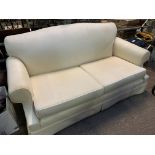 Cream upholstered two seat sofa