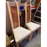 Two contemporary high back dining chairs