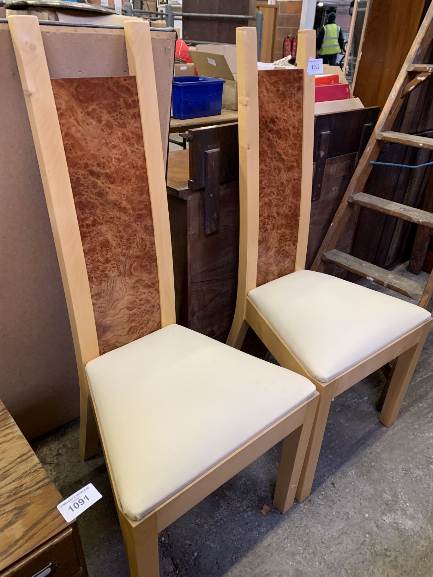 Two contemporary high back dining chairs