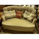Pale green buttoned back curved two seat sofa