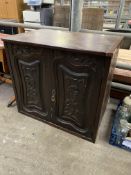 Hardwood cabinet with carved panels to doors