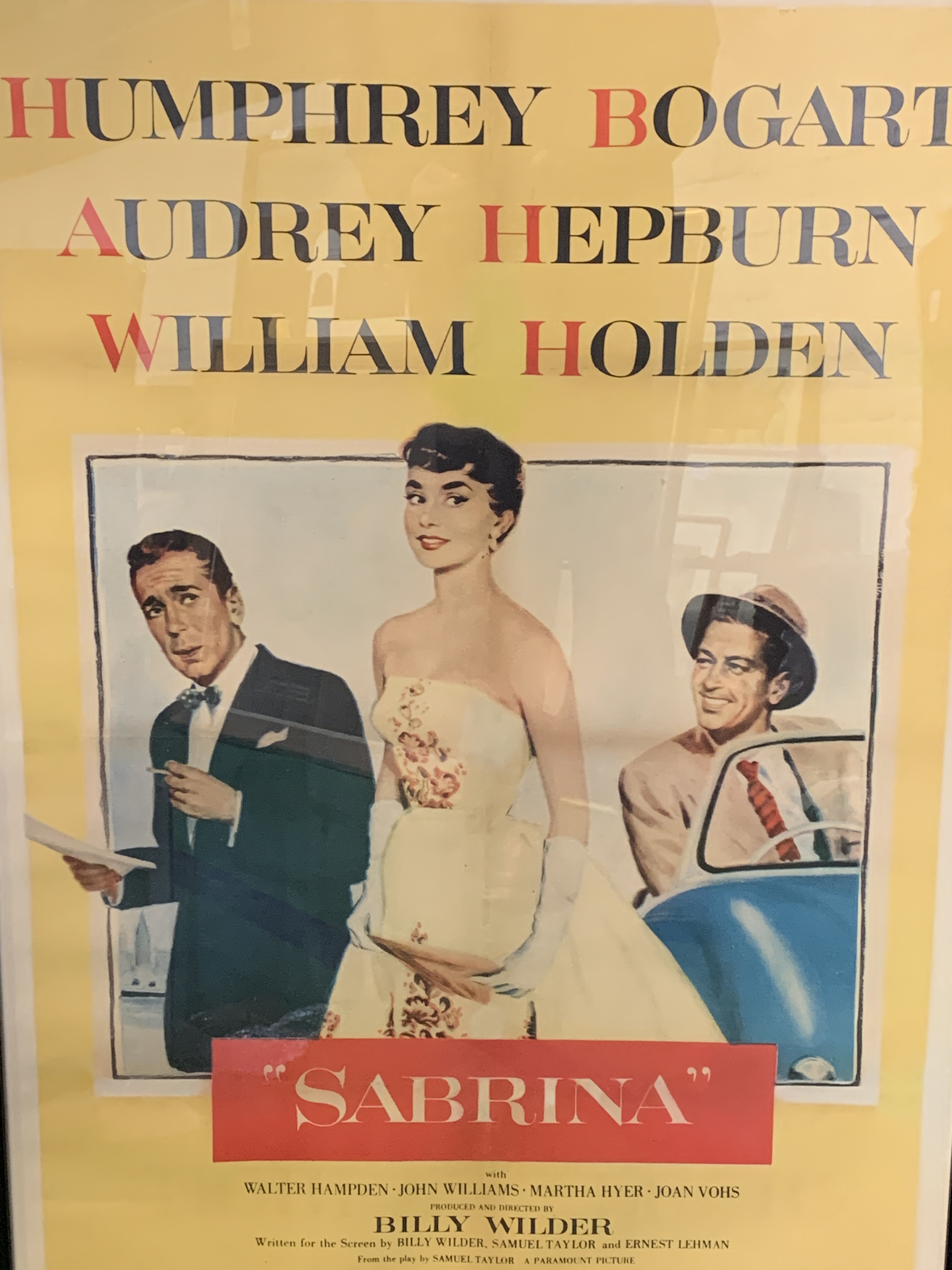 Two framed and glazed film posters: "Sabrina" and "Breakfast at Tiffany's"