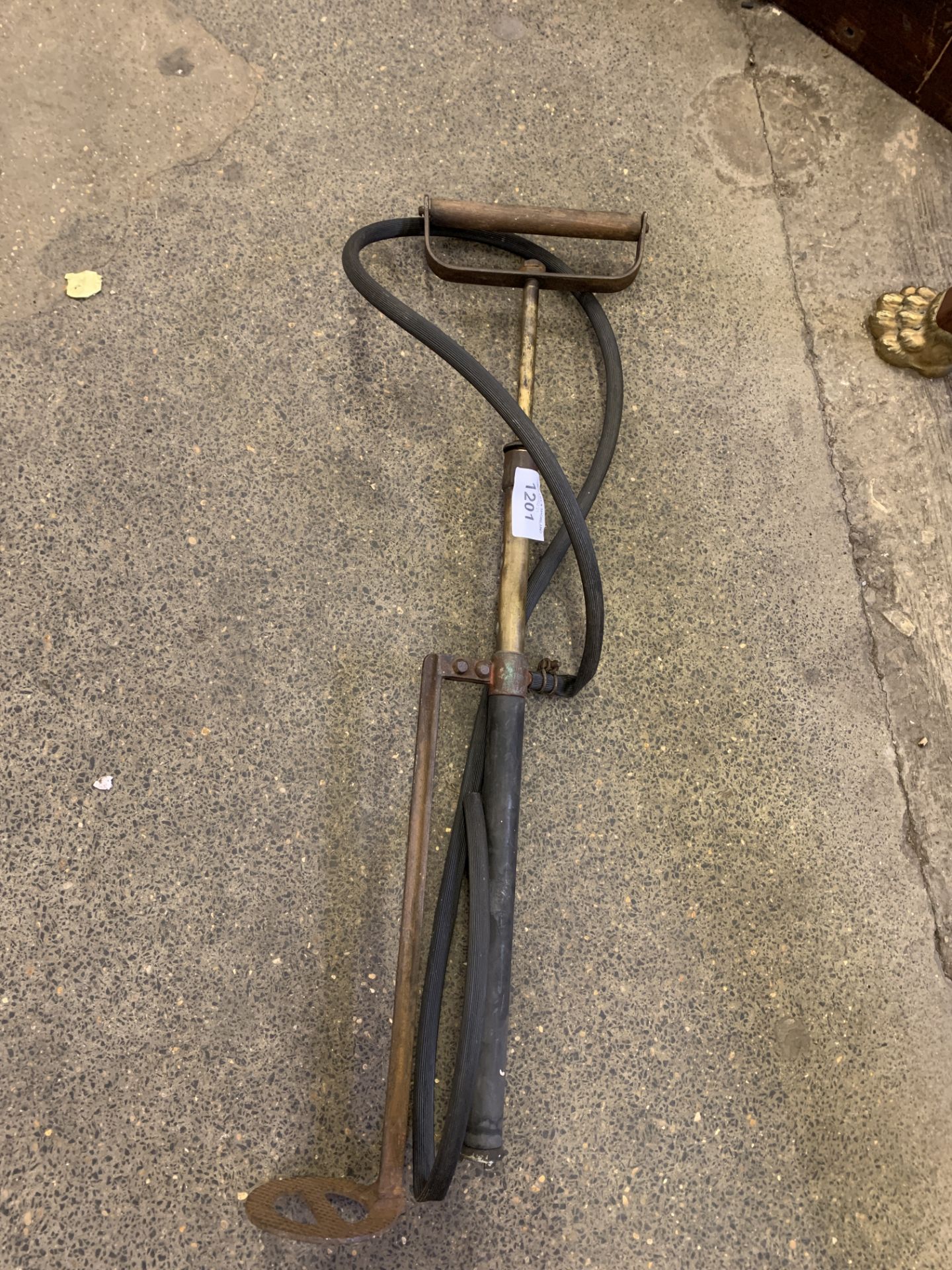 Foot stirrup water pump with hose. This item carries VAT.