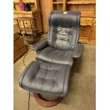 Dark blue leather upholstered reclining chair with footstool