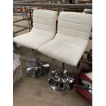 Two leather effect and chrome adjustable high chairs.