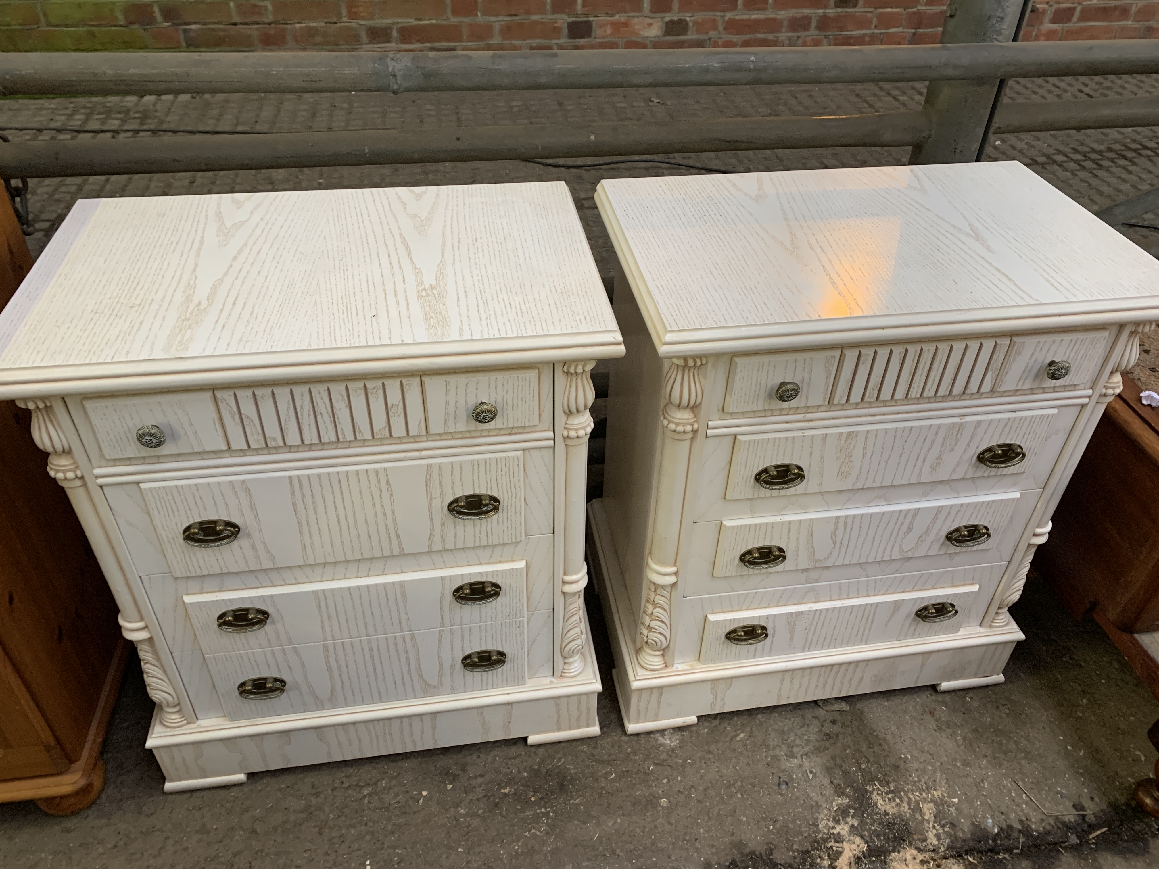 Pair of cream coloured four drawer bedside cabinets