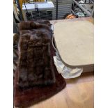 Two fur stoles and a small suitcase