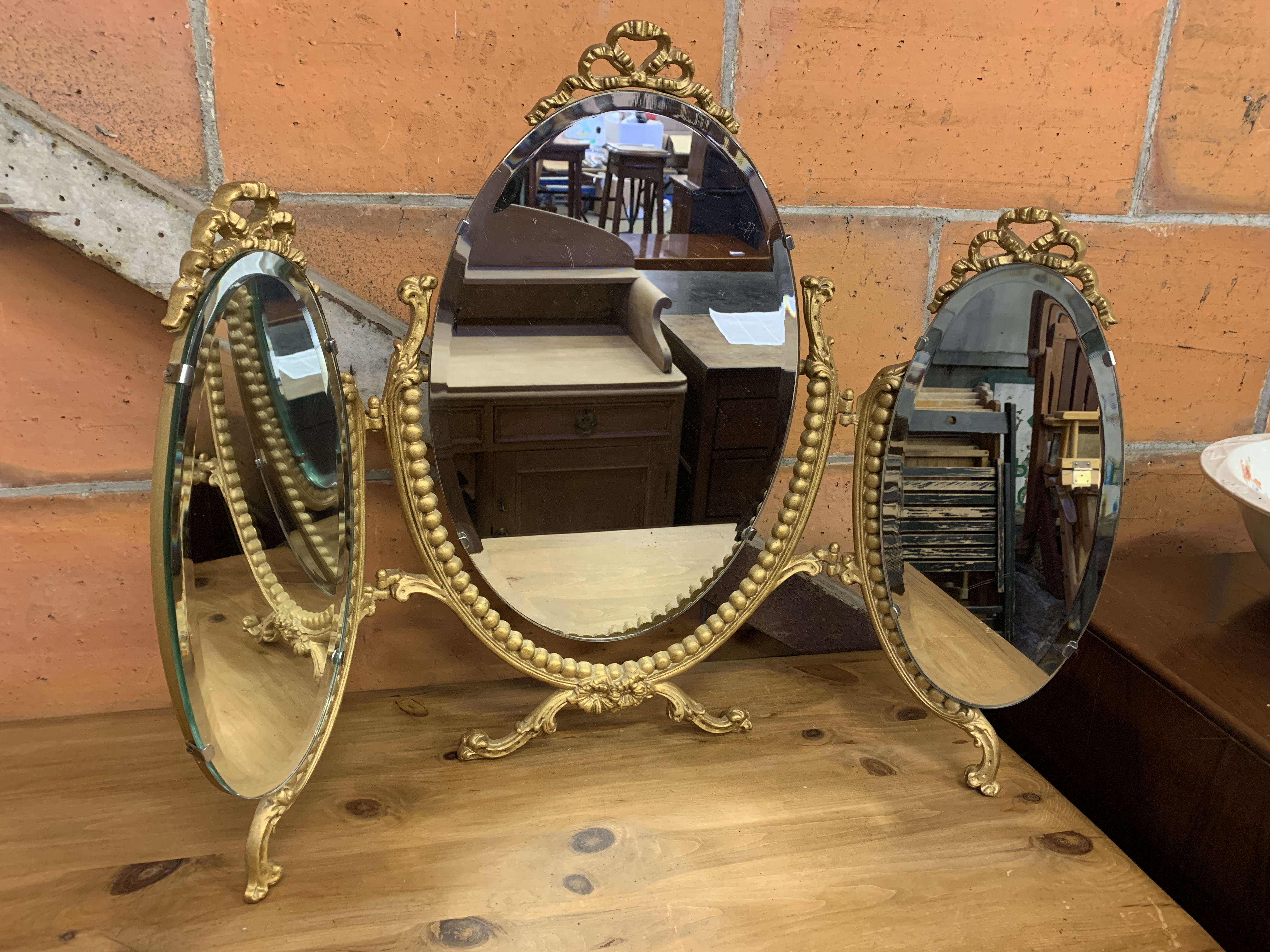 Gilt metal framed triple toilet mirror