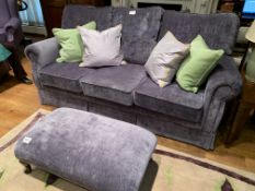 Purple upholstered three seat sofa and matching footstool,