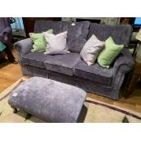 Purple upholstered three seat sofa and matching footstool,