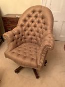 Brown upholstered button back and seat swivel armchair on casters