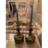 Pair of brass candlesticks with glass storm shades