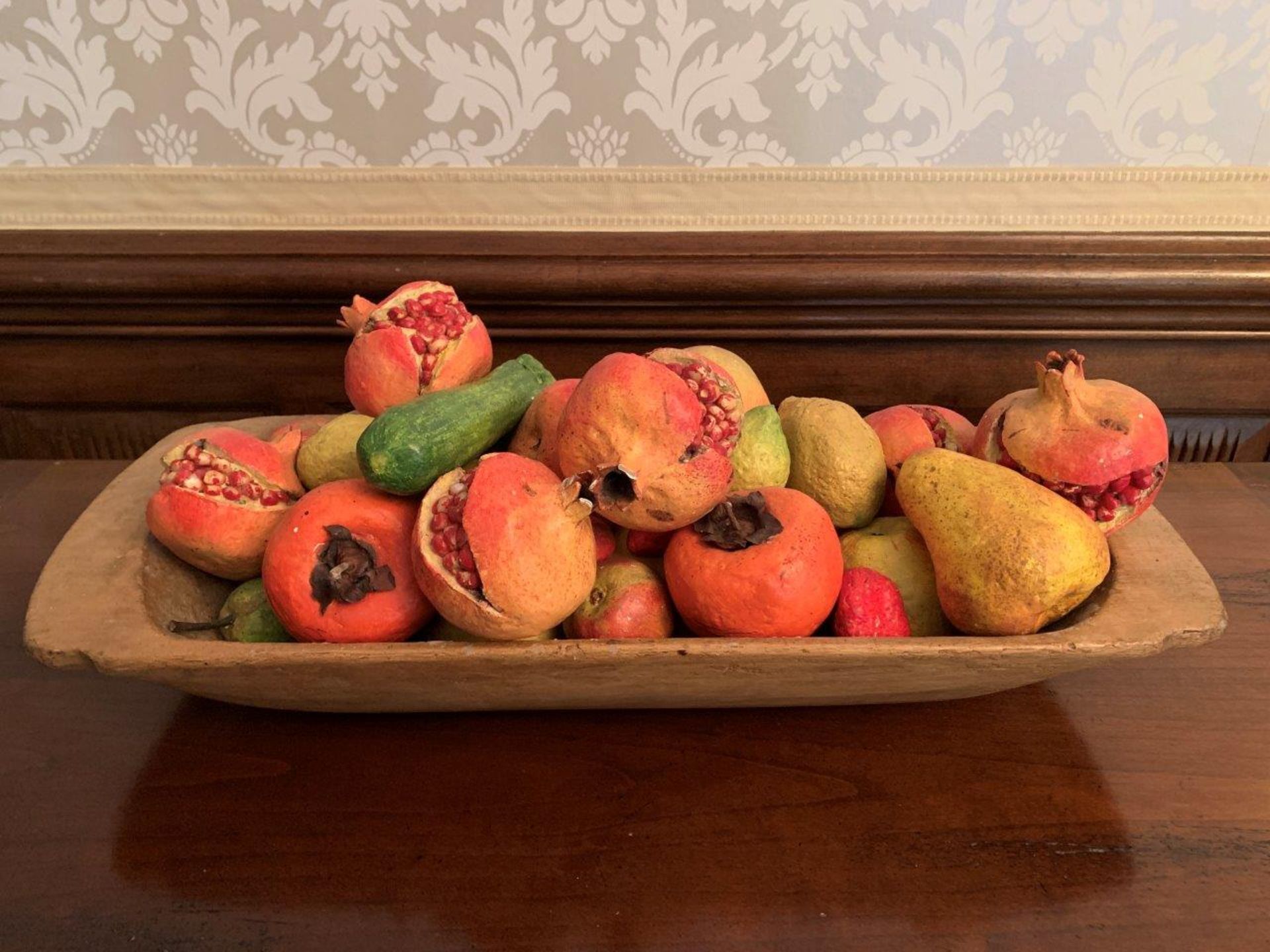 Wooden long dish containing a quantity of plaster "fruit"