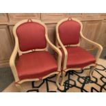 Two cream painted French style open arm chairs
