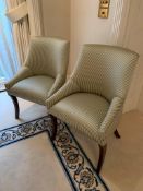 Two upholstered chairs in striped fabric, with sabre legs