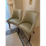 Two upholstered chairs in striped fabric, with sabre legs