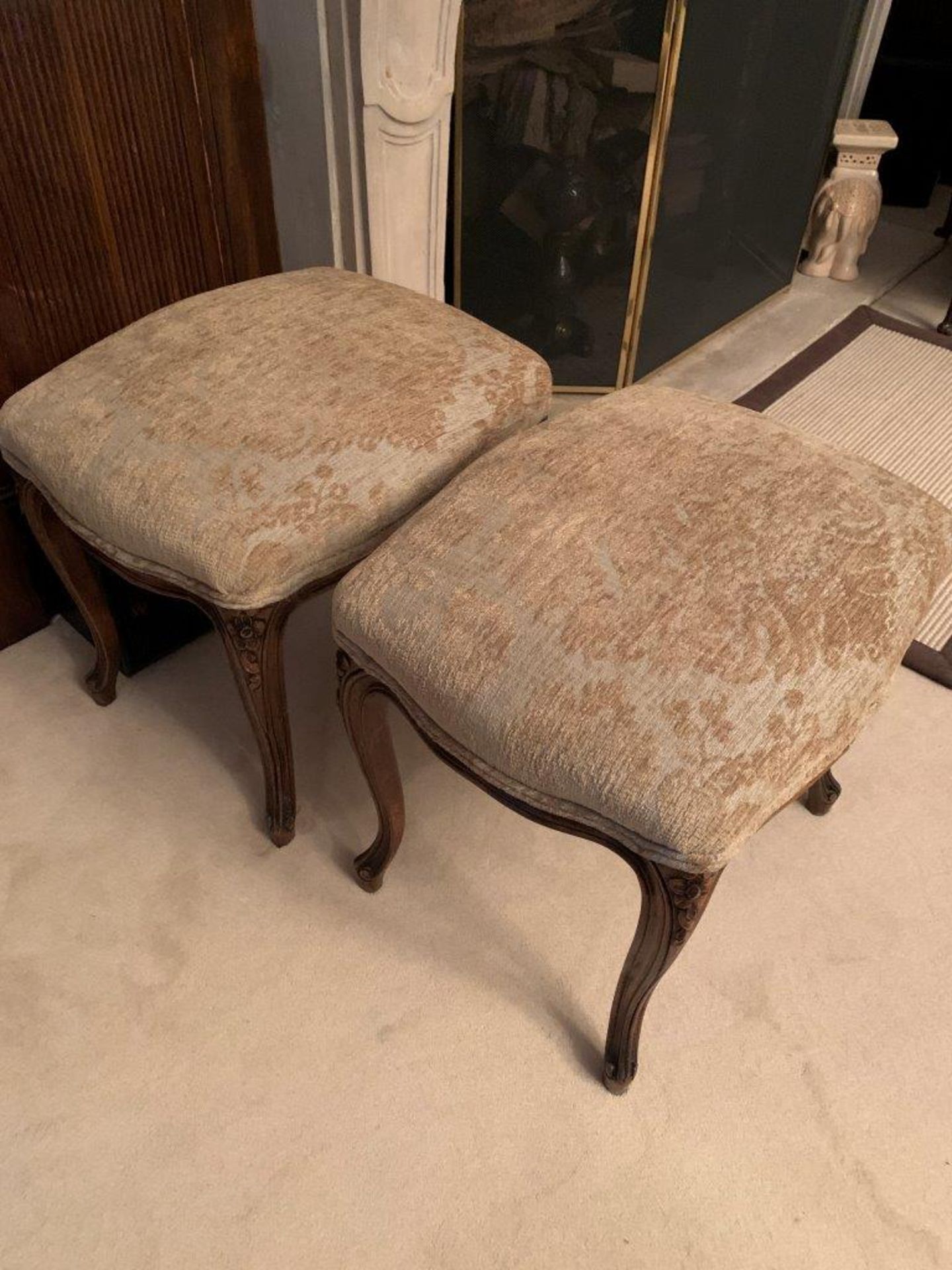 Pair of French style carved stools with upholstered seats